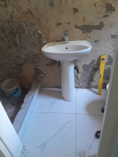 Pedestal basin installed in a bathroom mid-renovation by Hebert Electrical and Plumbing