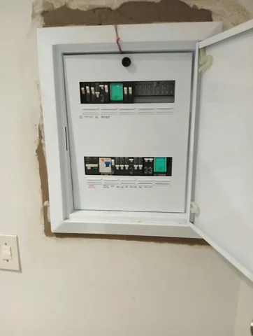 Residential distribution board with earth leakage unit and labelled circuit breakers during installation