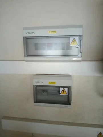 Two Volta electrical boxes with warning labels mounted vertically with cable trunking