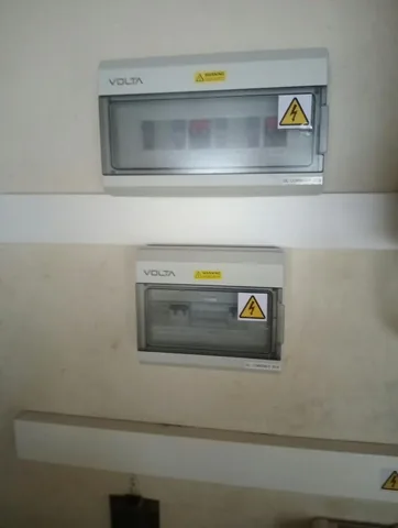 Volta AC and DC combiner boxes with high-voltage labels and white trunking