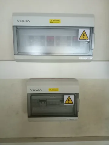 Volta DC combiner box stacked above an AC combiner box on a solar installation wall
